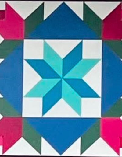 Barn quilt with an eight-pointed teal and aqua star at the center, framed by blue triangles and surrounded by four pink tulip blossoms with green leaves in the corners, on a white background.